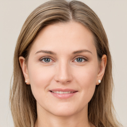 Joyful white young-adult female with long  brown hair and grey eyes