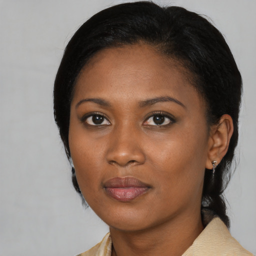 Joyful black young-adult female with medium  black hair and brown eyes