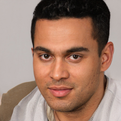 Joyful white young-adult male with short  black hair and brown eyes
