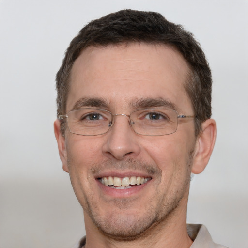 Joyful white adult male with short  brown hair and grey eyes