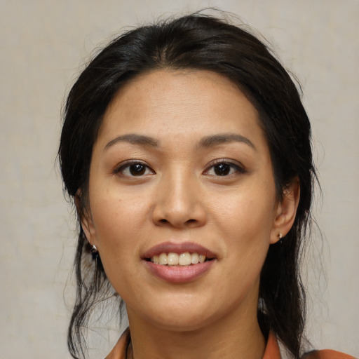 Joyful asian young-adult female with medium  black hair and brown eyes