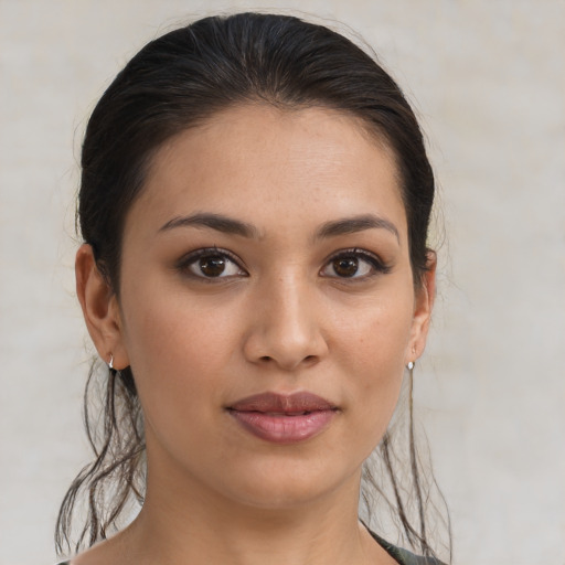 Joyful latino young-adult female with medium  brown hair and brown eyes