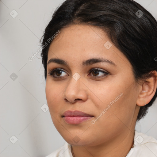 Joyful latino young-adult female with medium  brown hair and brown eyes