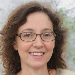 Joyful white adult female with medium  brown hair and brown eyes