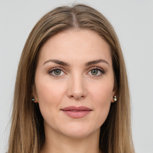 Joyful white young-adult female with long  brown hair and green eyes