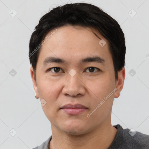 Joyful white adult male with short  black hair and brown eyes