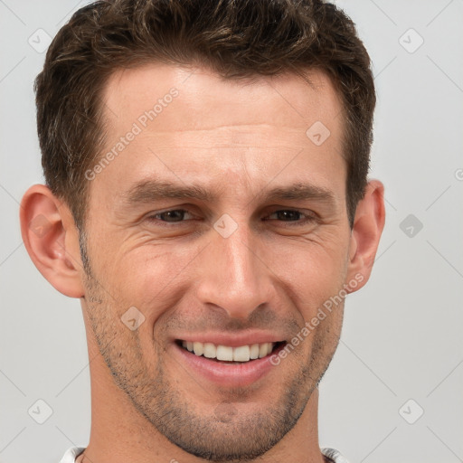 Joyful white adult male with short  brown hair and brown eyes