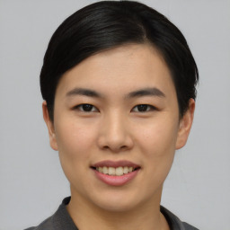 Joyful asian young-adult female with short  black hair and brown eyes