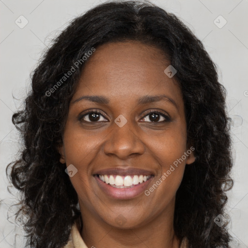 Joyful black young-adult female with long  brown hair and brown eyes