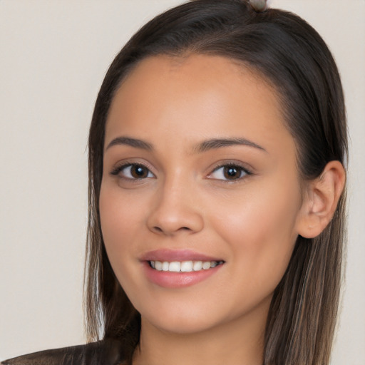 Joyful white young-adult female with long  brown hair and brown eyes