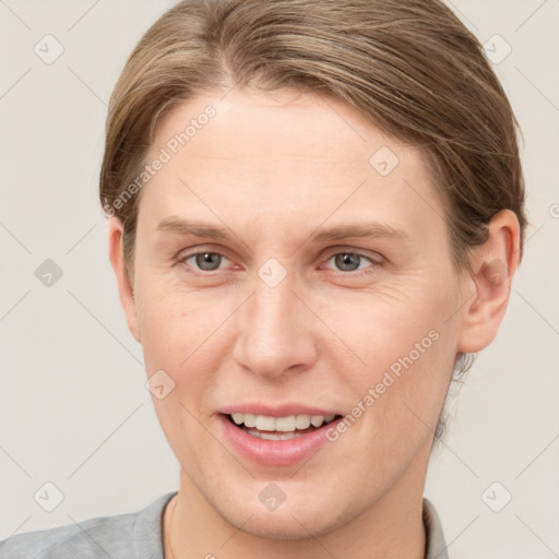 Joyful white young-adult female with short  brown hair and grey eyes