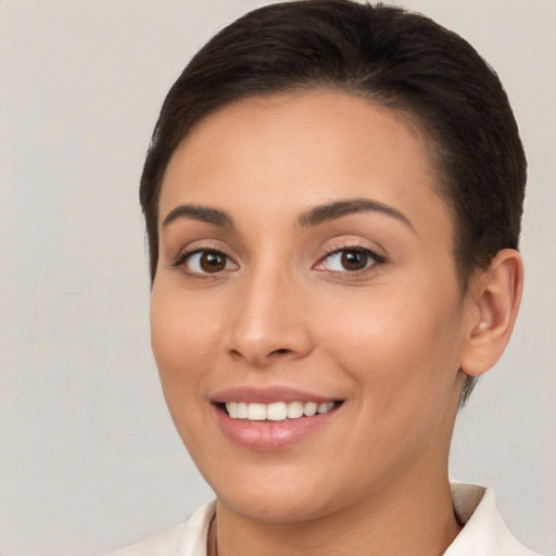 Joyful white young-adult female with short  brown hair and brown eyes