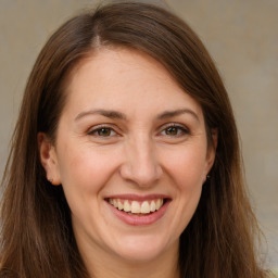 Joyful white adult female with long  brown hair and brown eyes