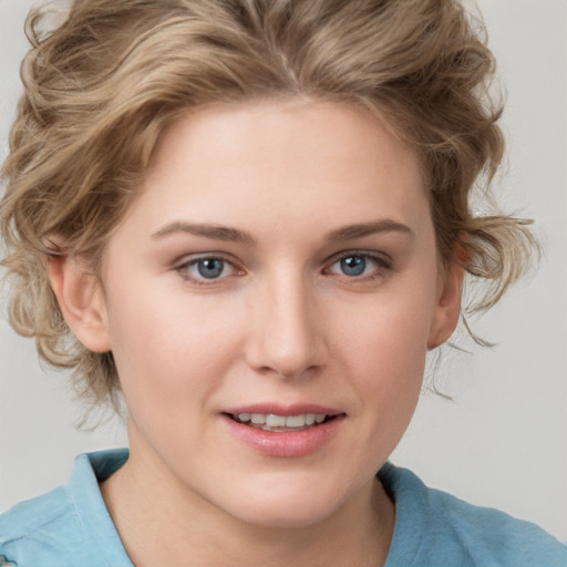 Joyful white young-adult female with medium  brown hair and blue eyes