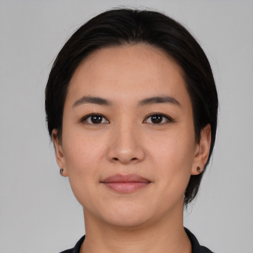 Joyful white young-adult female with medium  black hair and brown eyes