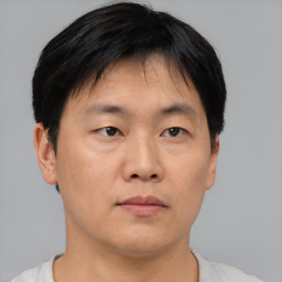 Neutral asian young-adult male with short  brown hair and brown eyes