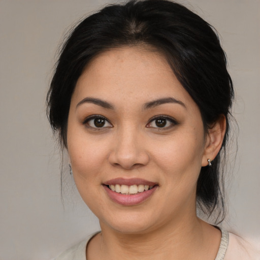 Joyful asian young-adult female with medium  brown hair and brown eyes