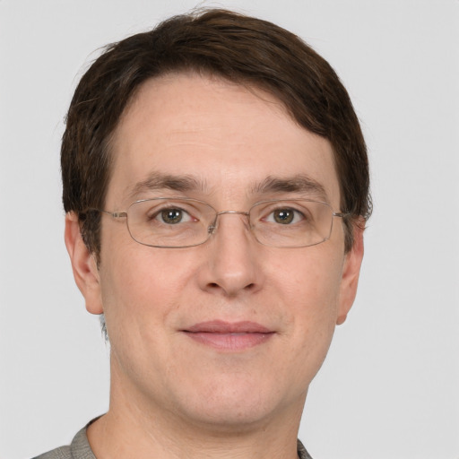 Joyful white adult male with short  brown hair and grey eyes