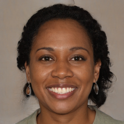 Joyful black young-adult female with medium  brown hair and brown eyes