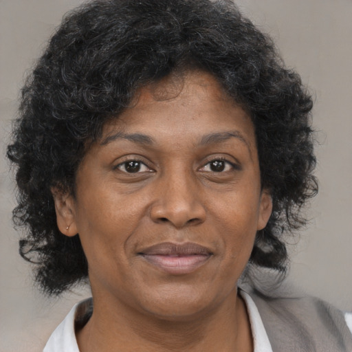 Joyful black adult female with short  brown hair and brown eyes