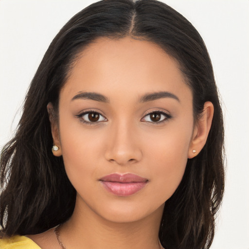 Joyful latino young-adult female with long  brown hair and brown eyes