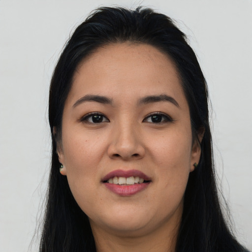 Joyful asian young-adult female with long  black hair and brown eyes
