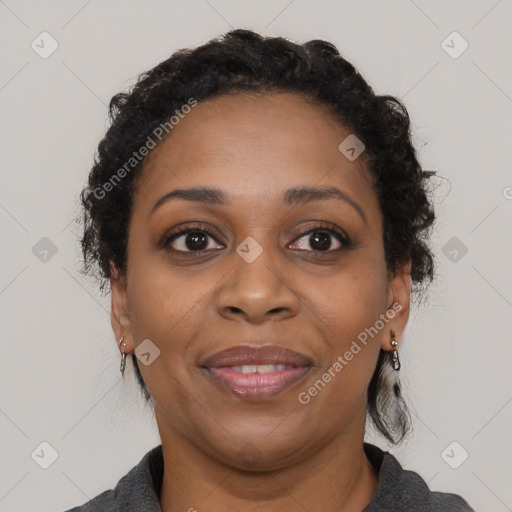 Joyful black adult female with medium  brown hair and brown eyes