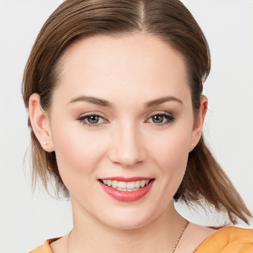 Joyful white young-adult female with medium  brown hair and brown eyes