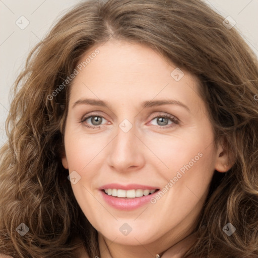 Joyful white young-adult female with long  brown hair and green eyes