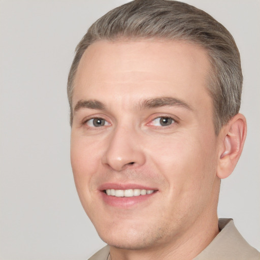 Joyful white adult male with short  brown hair and brown eyes