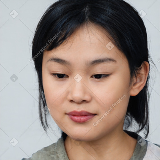 Joyful asian young-adult female with medium  black hair and brown eyes