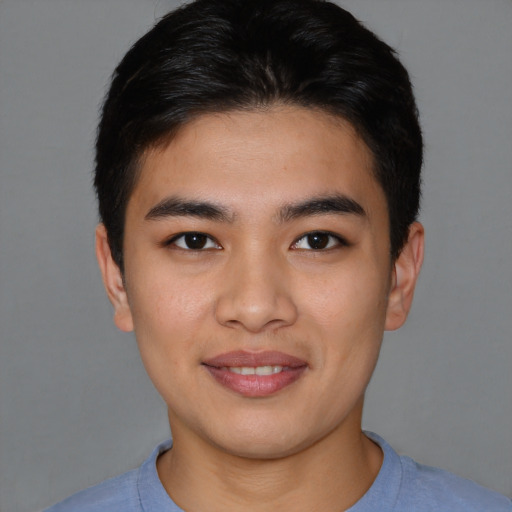 Joyful asian young-adult male with short  brown hair and brown eyes