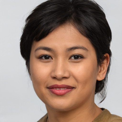 Joyful asian young-adult female with medium  brown hair and brown eyes