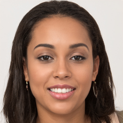 Joyful white young-adult female with long  brown hair and brown eyes