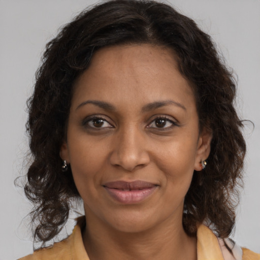 Joyful black young-adult female with medium  brown hair and brown eyes