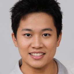 Joyful asian young-adult male with short  black hair and brown eyes