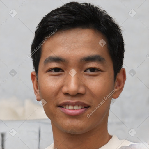 Joyful asian young-adult male with short  black hair and brown eyes