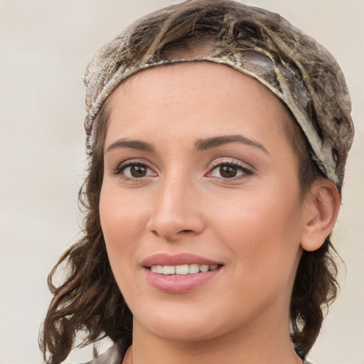 Joyful white young-adult female with medium  brown hair and blue eyes