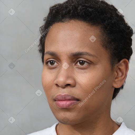 Joyful black young-adult male with short  brown hair and brown eyes