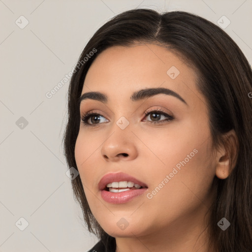 Joyful white young-adult female with long  black hair and brown eyes