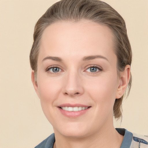 Joyful white young-adult female with medium  brown hair and blue eyes