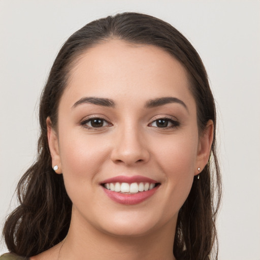 Joyful white young-adult female with long  brown hair and brown eyes