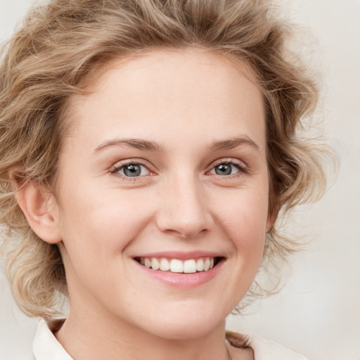 Joyful white young-adult female with medium  brown hair and blue eyes