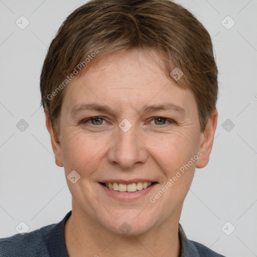 Joyful white adult female with short  brown hair and grey eyes