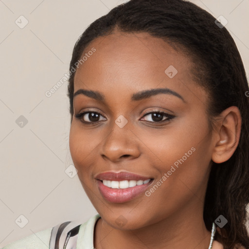 Joyful black young-adult female with long  brown hair and brown eyes