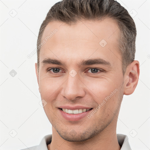 Joyful white young-adult male with short  brown hair and brown eyes