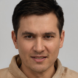 Joyful white adult male with short  brown hair and brown eyes