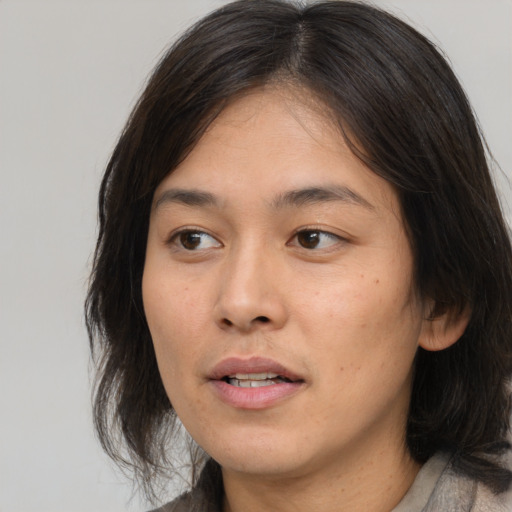 Joyful asian young-adult female with medium  brown hair and brown eyes
