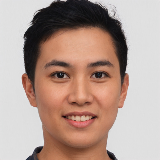 Joyful asian young-adult male with short  brown hair and brown eyes