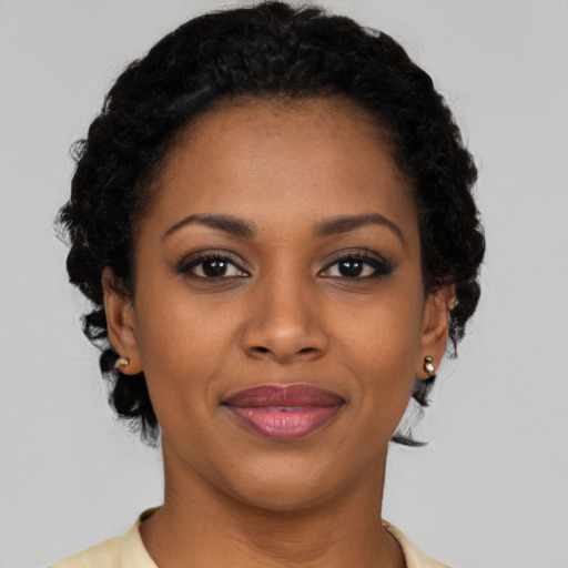 Joyful black young-adult female with short  brown hair and brown eyes